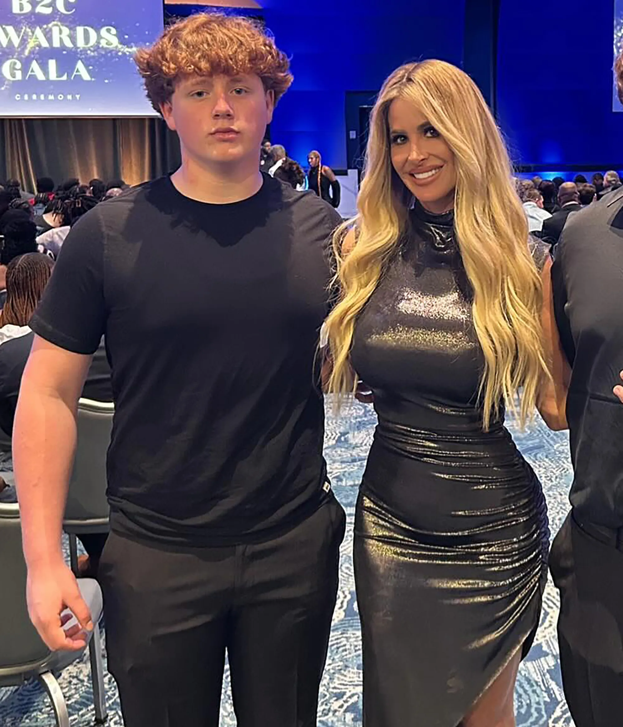 Kim Zolciak and her son KJ Biermann stand together at a gala event.