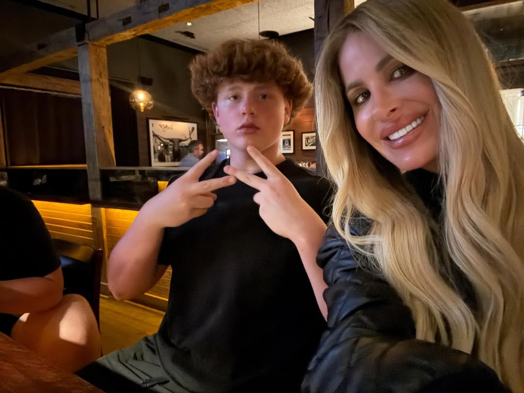 Kim Zolciak and her son KJ Biermann posing for a photo.
