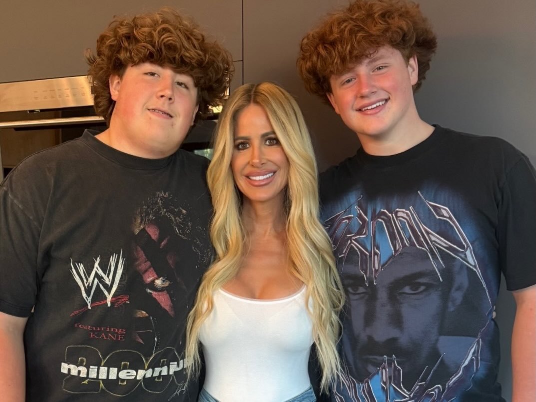 Kim Zolciak smiling with her two sons.