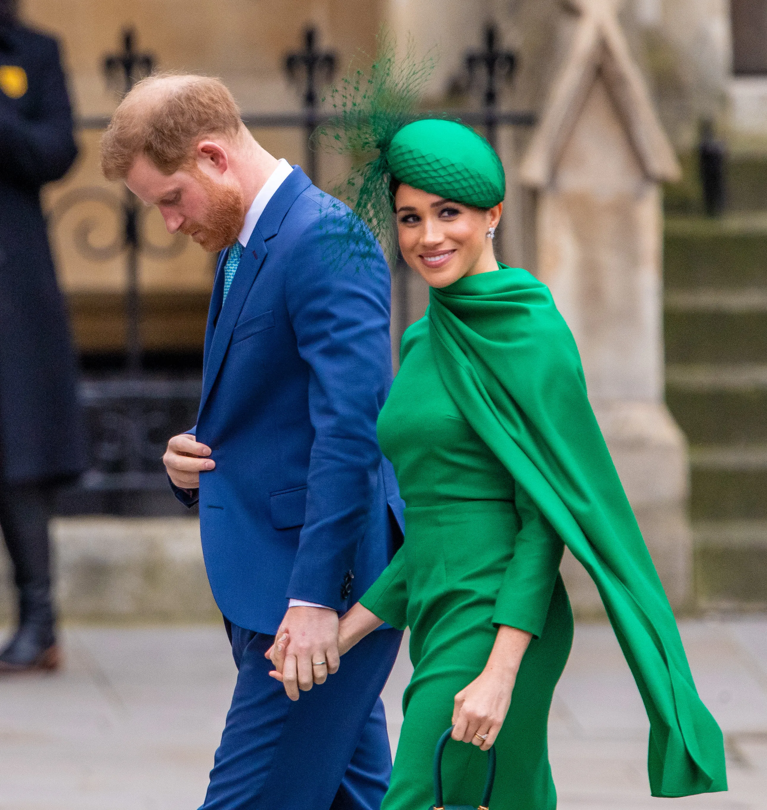 Prince Harry and Meghan Markle holding hands as they walk.