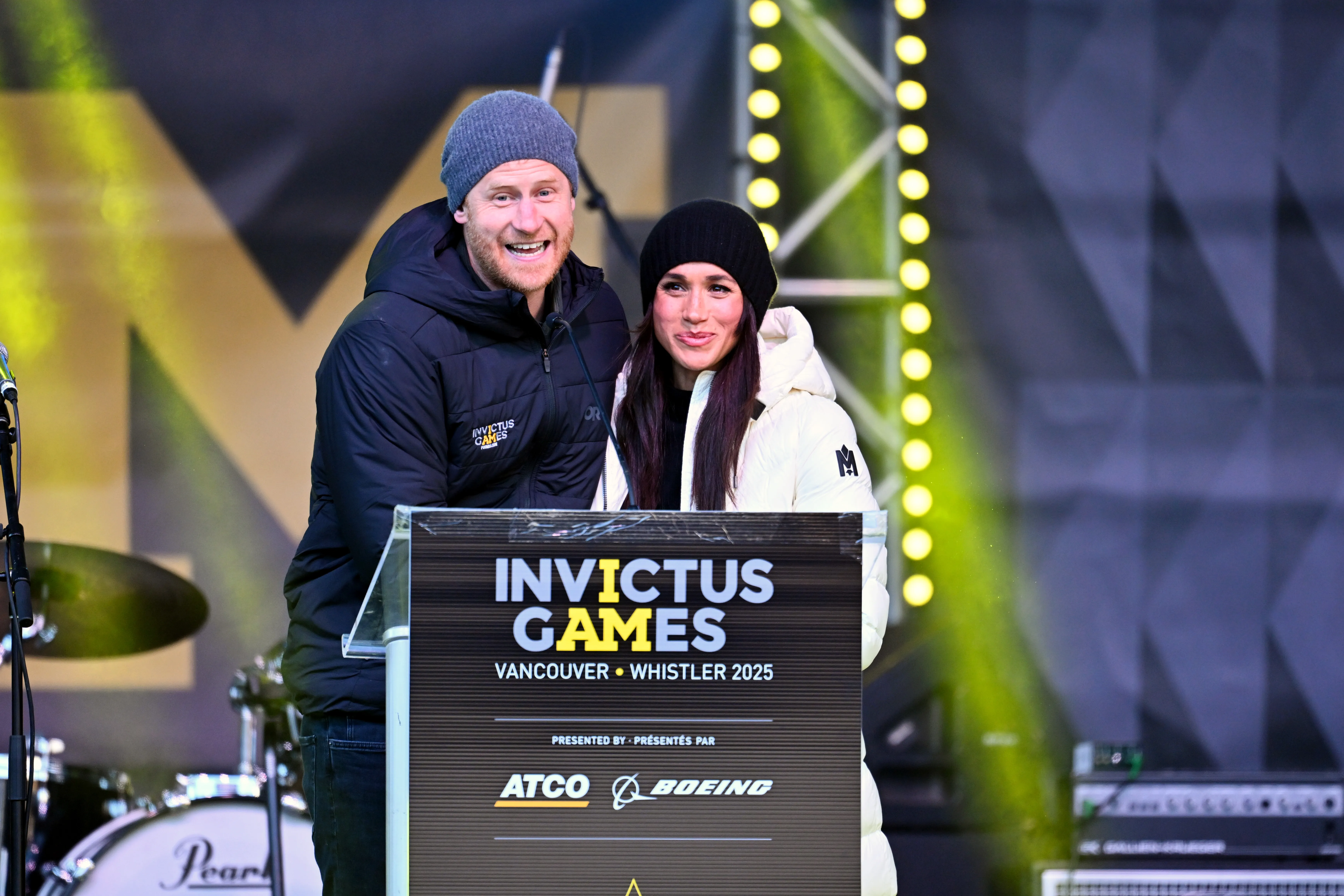 Prince Harry and Meghan Markle at a podium for the Invictus Games 2025.