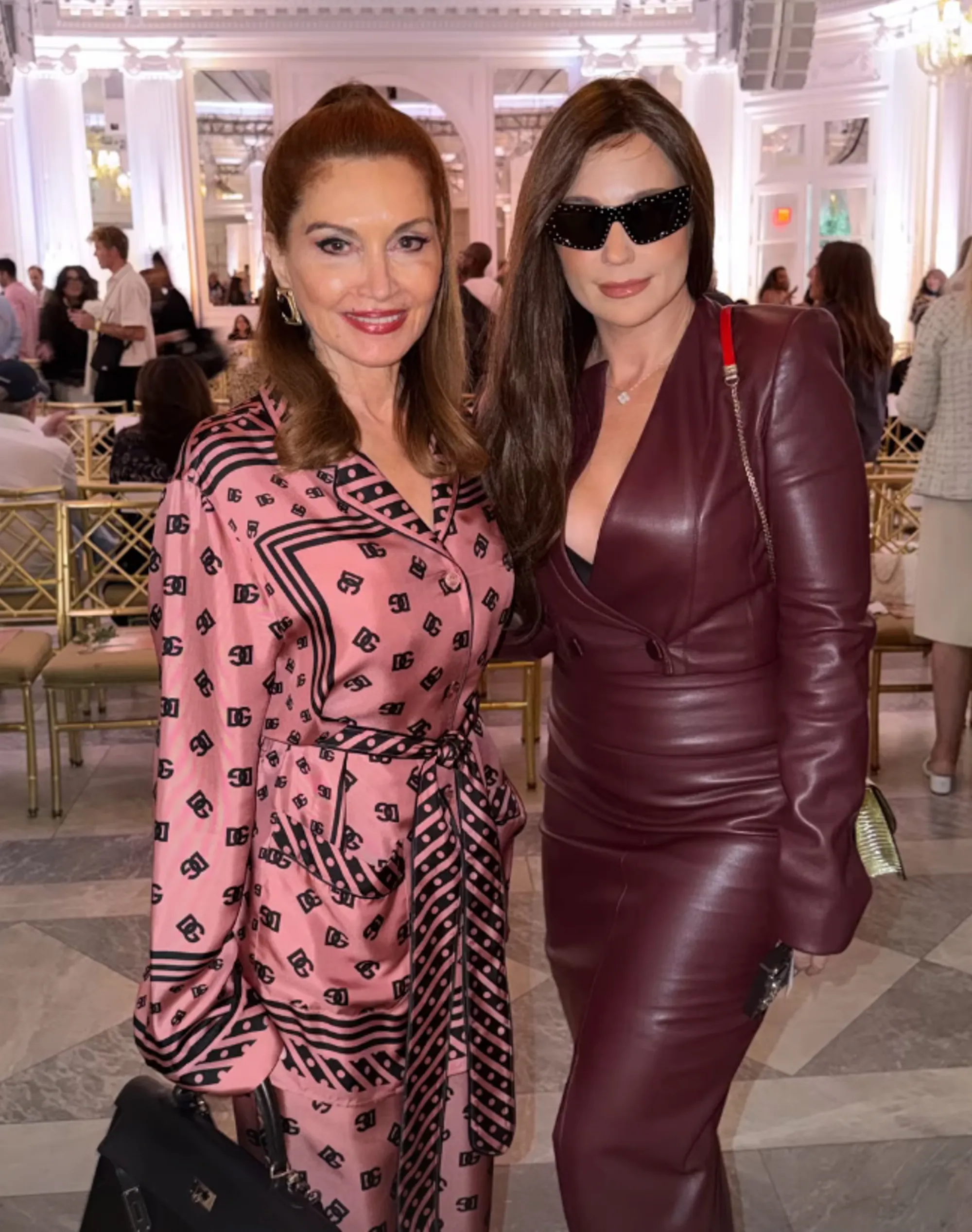 Singer Cara in a leather suit next to Jean Shafiroff at a fashion show.