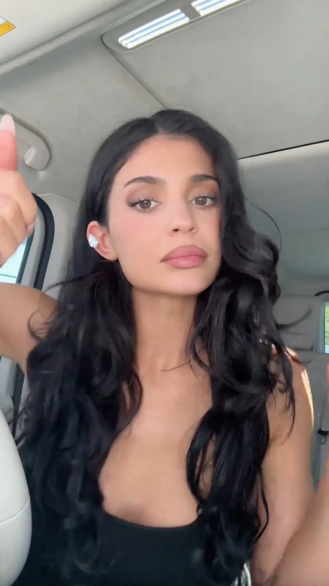 Kylie Jenner wearing a tear drop diamond earring.