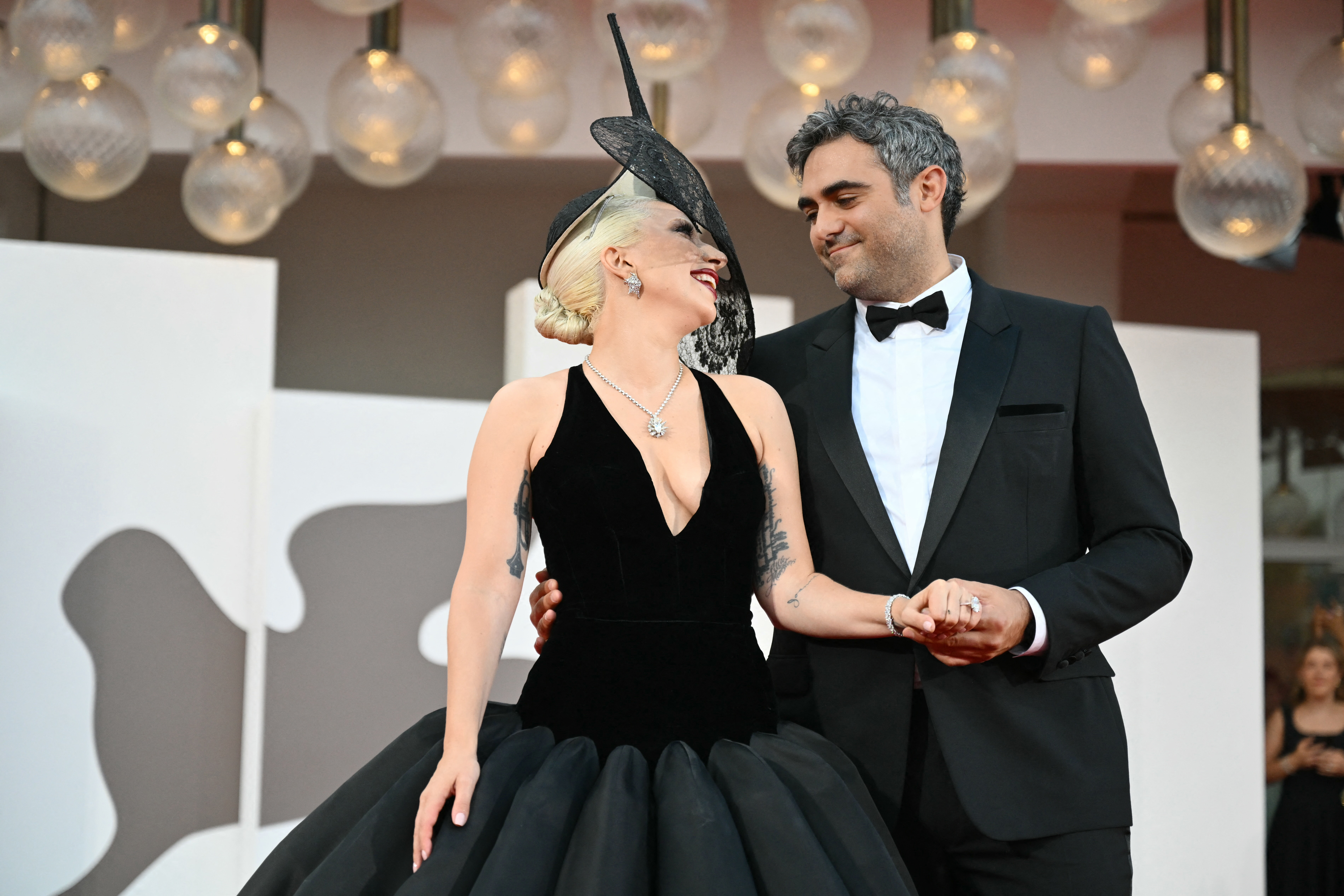 Lady Gaga in a black gown and Michael Polansky in a tuxedo at the "Joker: Folie a Deux" premiere.