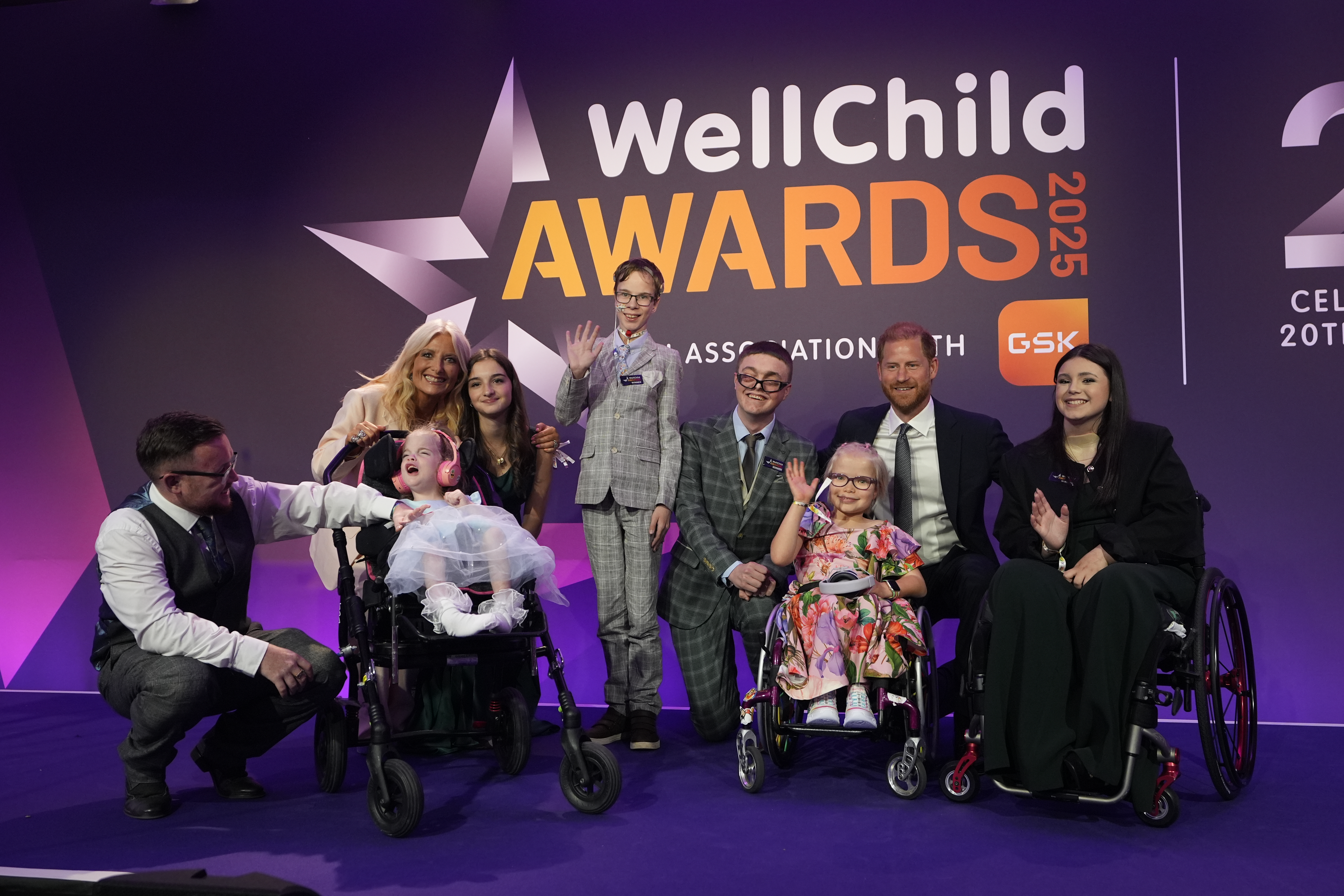 Prince Harry, Gaby Roslin, and award recipients Alessia Palikira, Ansel Hayward, Declan Bitmead, Esmee Mcglinchey, Gwen Foster, and Grace Tutt pose on stage at the WellChild Awards 2025.